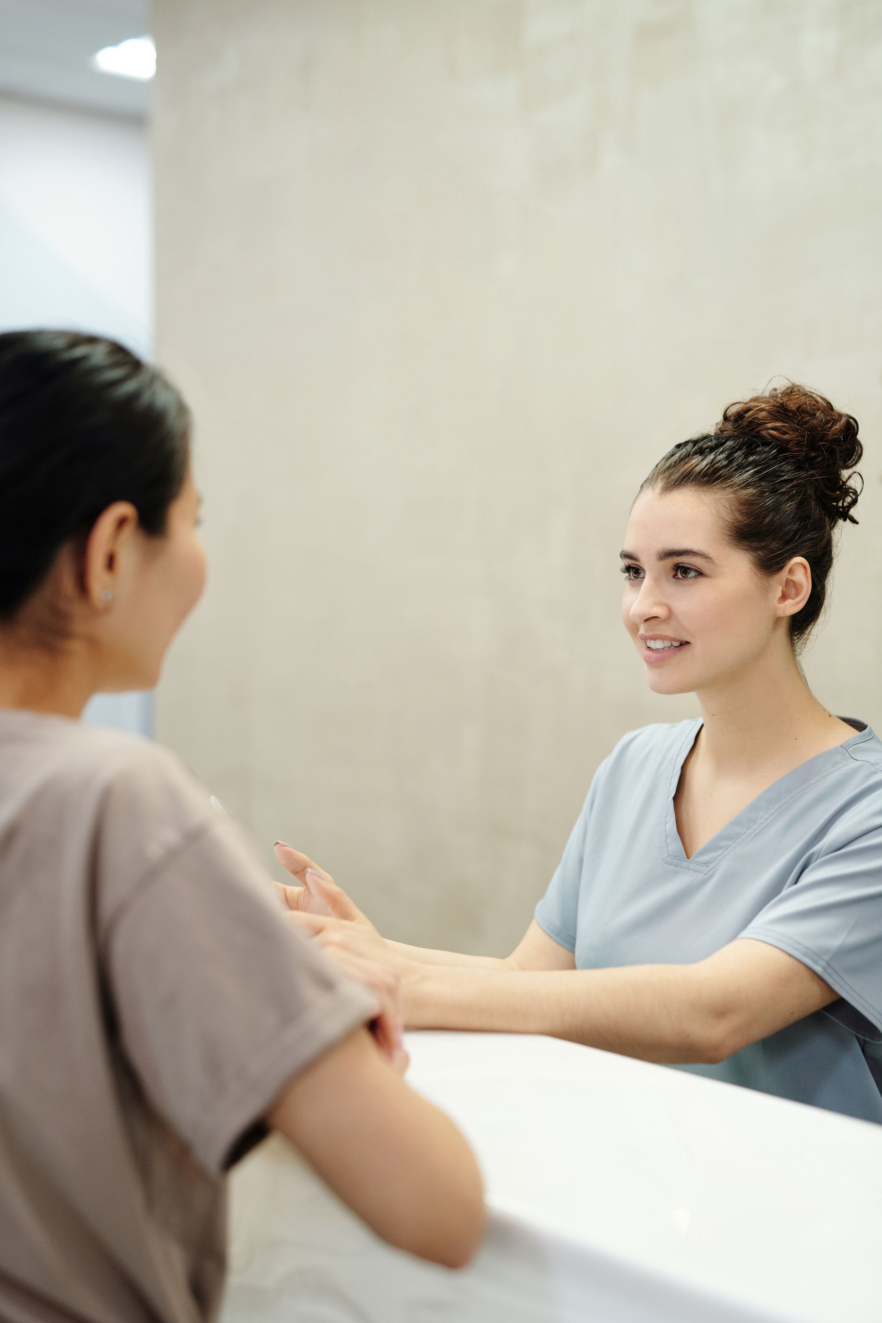 Front-desk coordinator speaking with a patient