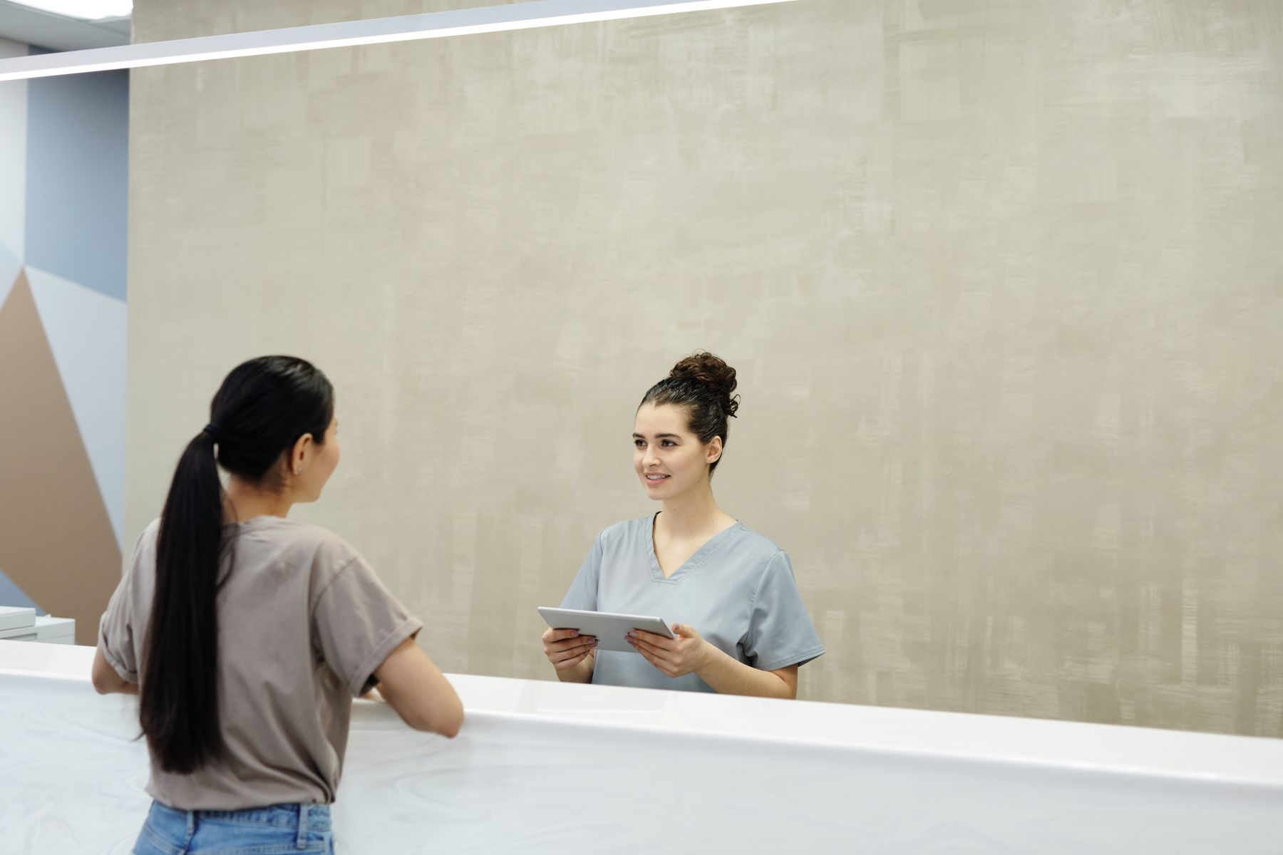 Coordinator using a tablet to check in a patient